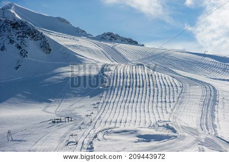Alpine winter mountain landscape. French Alps covered with snow in sunny day. Val-d'Isere, France