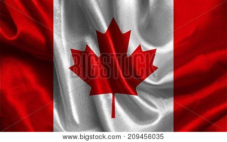 Realistic flag of Canada on the wavy surface of fabric. This flag can be used in design.