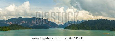 Panorama Of Lake Cheo Lan, Karst Mountains Against A Background Of Clouds
