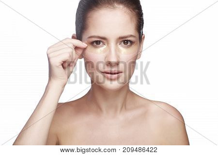 portrait of a girl on a white background with patches for the eyes