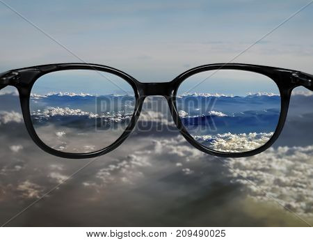 Clear Vision Through Glasses On Blue Clouds Landscape