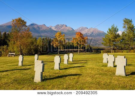 German military cemetery in autumn with  mountains in the background and many graves of soldiers killed in the Second World War.