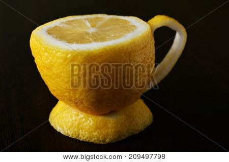 a cup of lemona cup of lemon on a wooden table