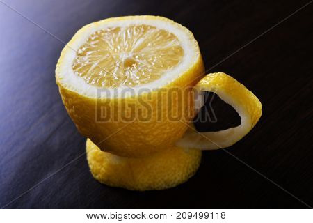 a cup of lemona cup of lemon on a wooden table