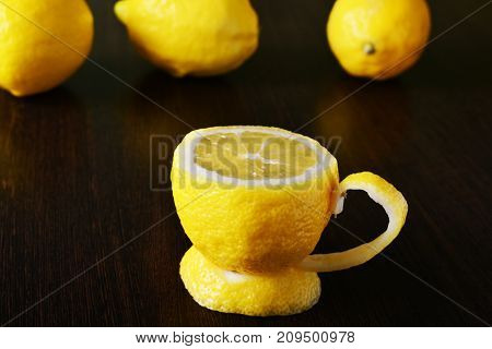 a cup of lemona cup of lemon on a wooden table