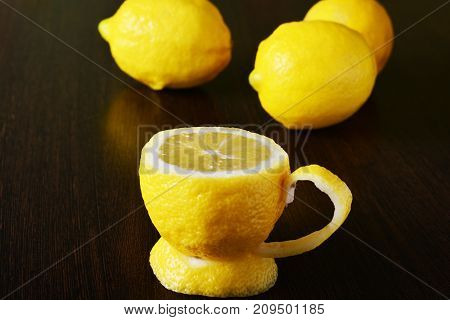 a cup of lemona cup of lemon on a wooden table