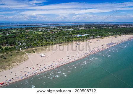 Italy, the beach of the Adriatic sea. Rest on the sea near Venice. Aerial FPV drone photography.