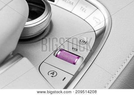 Media and navigation control buttons of a Modern car. Car interior details. White leather interior of the luxury modern car. Modern car interior. Black and white