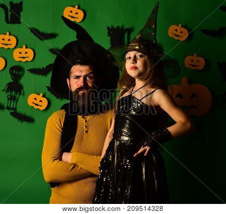 Wizard And Little Witch In Black Hats. Father And Daughter