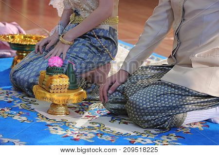 Groom and bride with tray of gift in traditional Thai wedding ceremony. Concept of marriage.