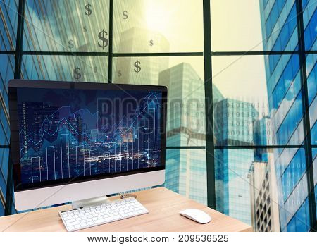 the computer on the wood table in front of the glass window over the blurred photo of cityscape background