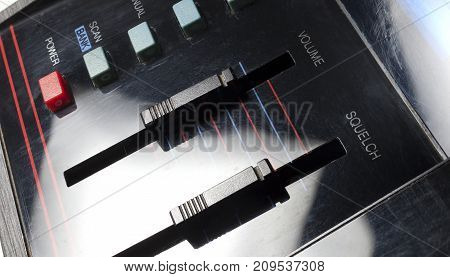 Long sliders on an old radio to control volume and squelch
