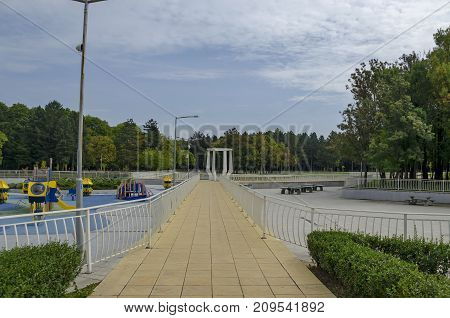 Popular  North park  for rest with autumnal old forest, bench, open-air kindergarten and lake in  Vrabnitsa district, 

Sofia, Bulgaria
