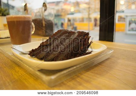 Cake and coffe in front of a window.