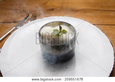 Ice Cream Sweet Dessert On A White Plate On A Wooden Table In An Italian Retor. Ingredients White Ic