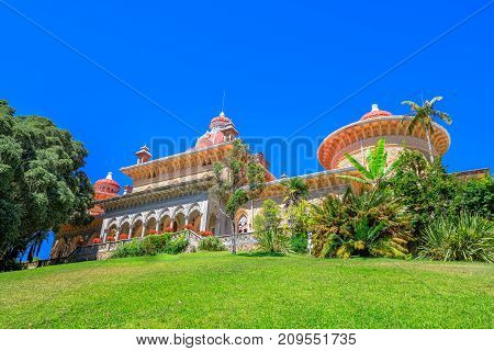 Sintra, Portugal. The Monserrate Palace surrounded by botanical park in beautiful sunny day. Palacio de Monserrate is the summer resort of the Portuguese court.
