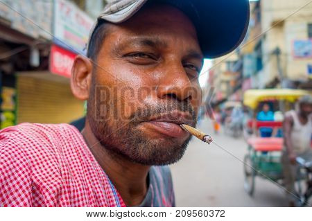 Delhi, India - September 25, 2017: Portrait of Indian man smoking in the streets of Paharganj new delhi India.