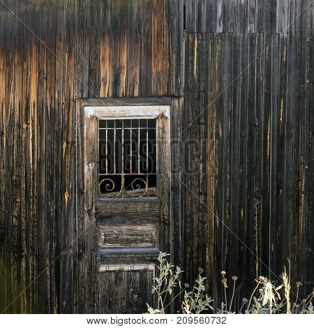 Old hovel. Wooden door with a lattice.