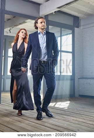 stylish actors posing on a concrete background with pompous expression