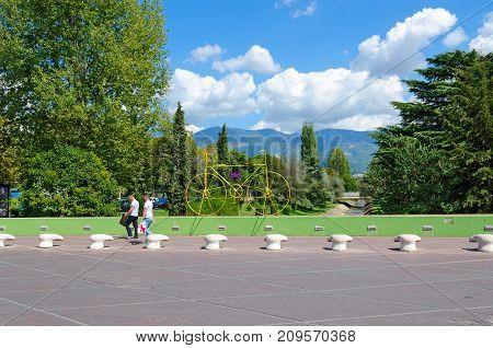 TIRANA ALBANIA - SEPTEMBER 6 2017: Unknown people walk along bridge over Lana River (Rruga Ibrahim Rugova) Tirana Albania