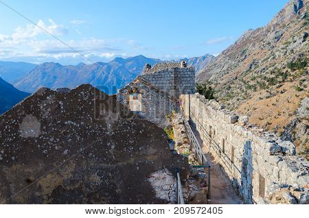 KOTOR MONTENEGRO - SEPTEMBER 8 2017: Ruins of ancient fortress of St. John (Illyrian Fort) over city of Kotor and Bay of Kotor Montenegro