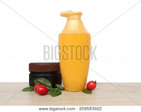 Two jars of cream and berries against a white wall. daily care