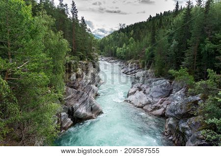 View from the Keksbroe bridge to the rocky banks of the Sjoa river