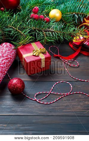 Red Christmas  Gift  Box With Red Ribbon And Fir Branches
