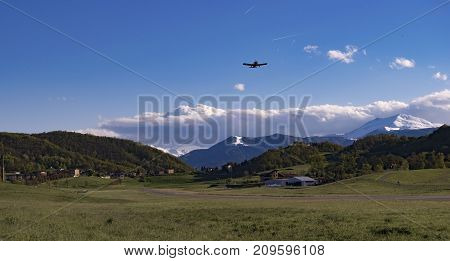 An airplane takes off from small Pavullo airport