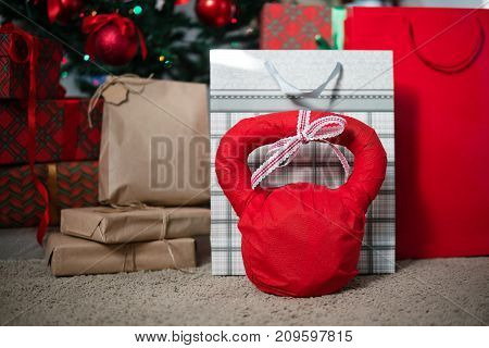 Christmas presents. Weight for fitness in red gift paper.