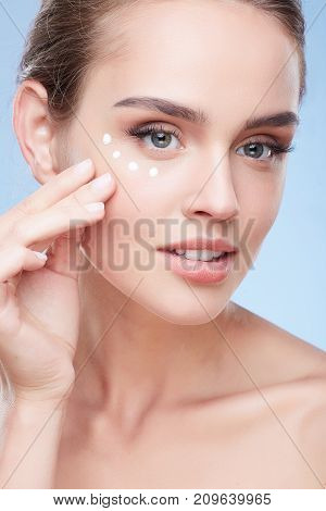 Woman Applying Cream Under Eyes