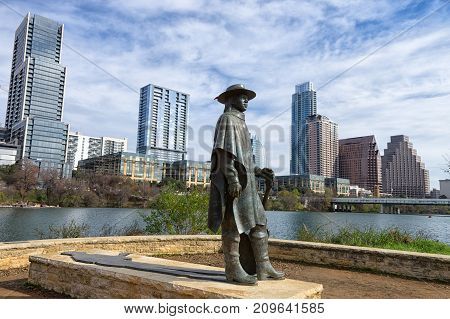 December 31, 2015 Austin Texas USA: bronze sculpture of Stevie Ray Vaughan by Ralph Helmic with the downtown in the background