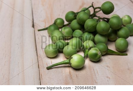 Turkey Berry (solanum Torvum Sw.) On A Wooden Floor