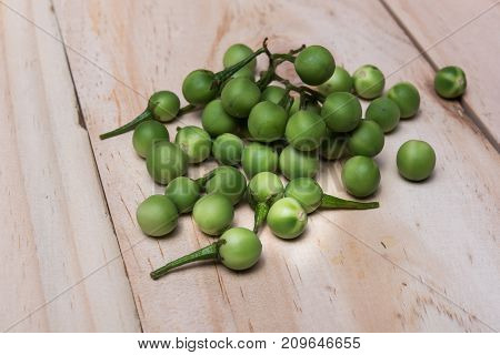Turkey Berry (solanum Torvum Sw.) On A Wooden Floor