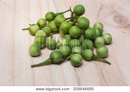 Turkey Berry (solanum Torvum Sw.) On A Wooden Floor