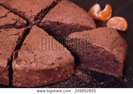 Chocolate Mud Cake with mandarin on the table