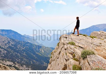 Standing over the precipice in the mountains of Olympus Greece.