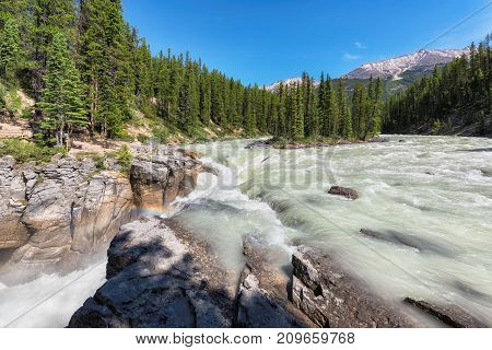 Small island and Sunwapta falls in Rocky Mountains, Jasper National Park, Alberta, Canada.