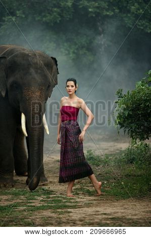 Thai woman wearing traditional dress in Chang village Surin Province Thailand.