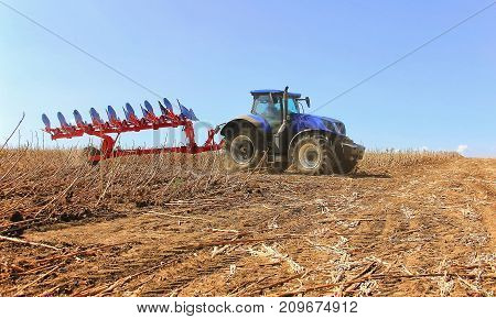 Close-up Work Of A Combine Harvester With A Wheat Field