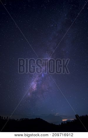 Long exposure and High ISO shot of star and milky way over the mountain at night. Blue tone effect.