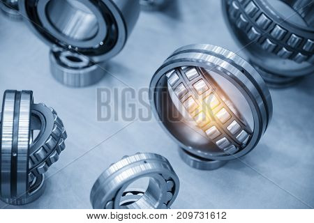 The metal ball bearing spare part on the violet carpet.The hi-precision mechanical part.
