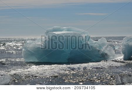 Icelandic waters with a large iceberg in the summer