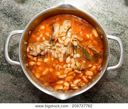 sheep stew with white beans in a saucepan