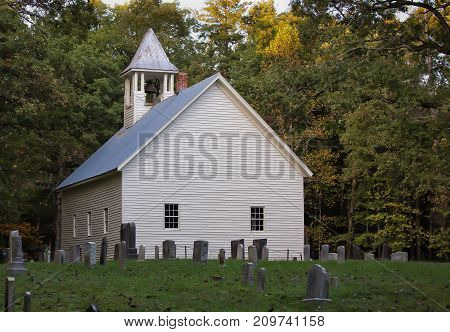 Country church and old family graveyard on a summer day