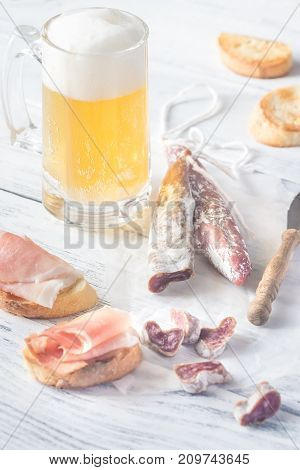 Mug Of Beer With Sandwiches And Smoked Sausage