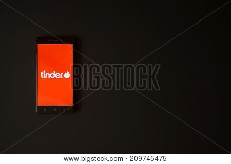 Los Angeles, USA, october 19, 2017: Tinder logo on smartphone screen on black background.