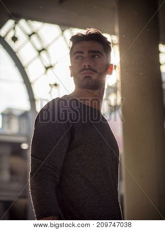 Attractive young bearded man portrait in urban environment