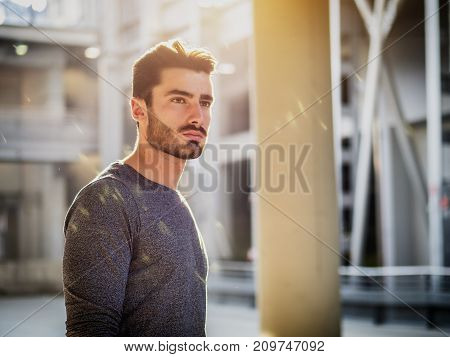 Attractive young bearded man portrait in urban environment
