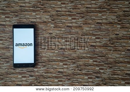 Los Angeles, USA, october 19, 2017: Amazon logo on smartphone screen on stone facing background
